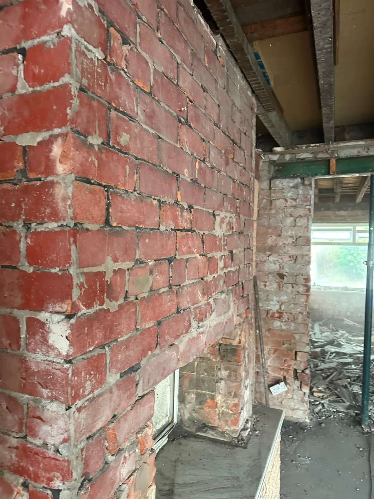 Internal brick wall and chimney breast exposed after a soft strip out