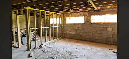 Open-plan commercial area preparation and non-load-bearing wall removal.