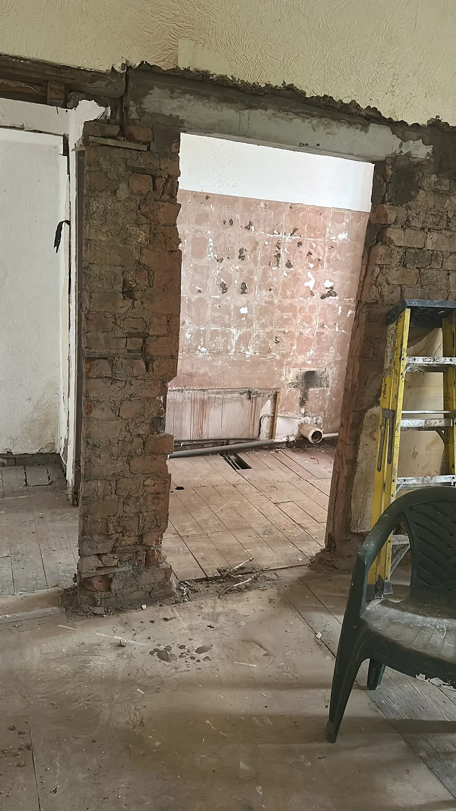 Internal doorway and surrounding wall stripped back to brick