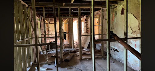 Demolition and layout framing for commercial corridors and pathways.