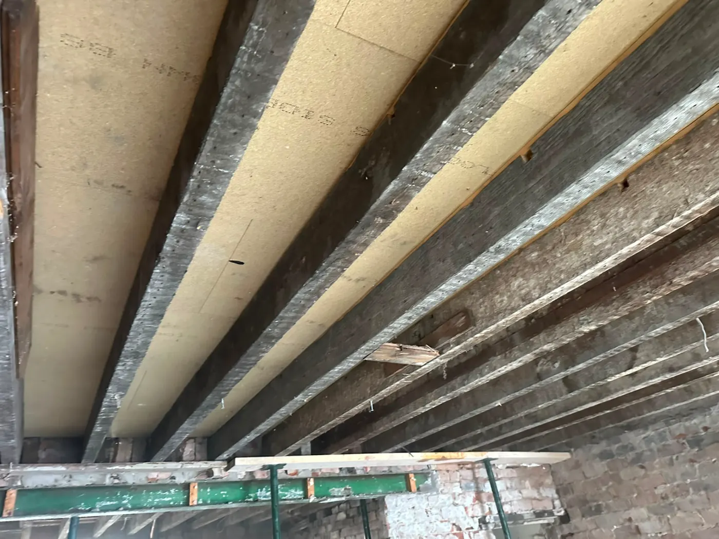 Exposed timber ceiling joists after plasterboard and ceiling removal during a strip out